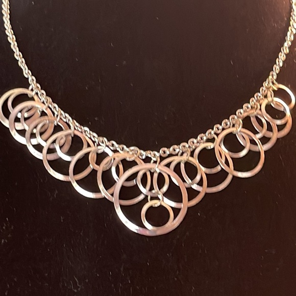 Light silver toned necklace with a variety of circles suspended on silver chain - Picture 2 of 13